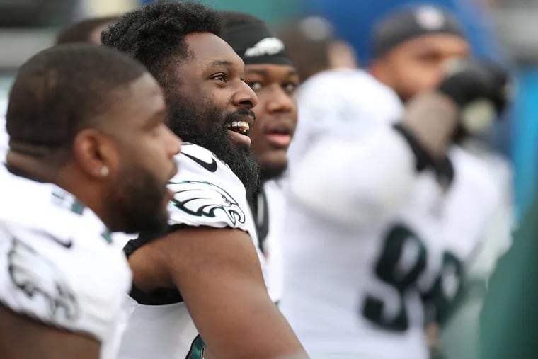 Philadelphia Eagles defensive end Josh Sweat (second from left) smiles as he rests on the bench. The Philadelphia Eagles play the Washington Football Team in Landover, Md. on Sunday, Jan. 2, 2022.