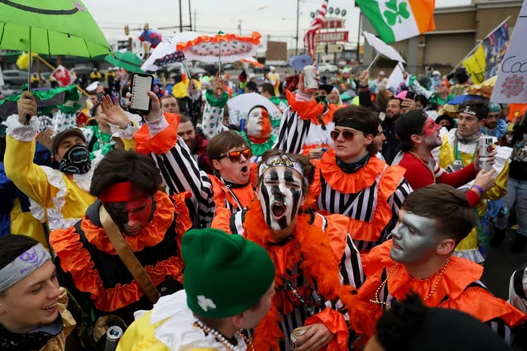 Mummers celebrate as their unofficial parade ends at 3rd Street and Oregon Avenue.
