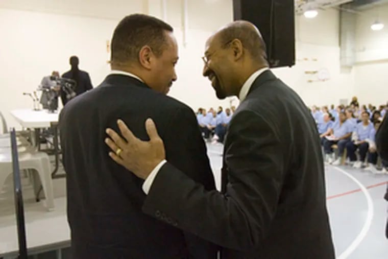 Mayoral candidate Michael Nutter (right) greets Prison Commissioner Leon King at the Riverside Correctional Facility. Inmates asked Nutter about his prisoner reentry tax-credit plan.