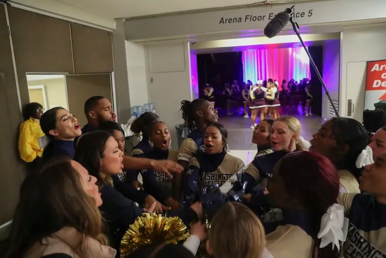 The George Washington High School cheer team huddles before they enter the arena to perform on the first day of competition at the Kay Bailey Hutchison Convention Center in Dallas, Texas, on Jan. 21. The team became the first Philadelphia School District cheerleaders in history to qualify for nationals.