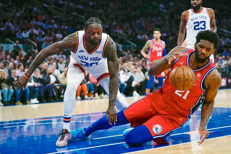 The 76ers' Joel Embiid fights for control of the ball with New York's Julius Randle during the first half.