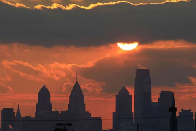 File - The sun is seen low in the sky before it sets behind the city skyline  Friday, Jan. 14, 2011. (AP Photo/Matt Rourke)