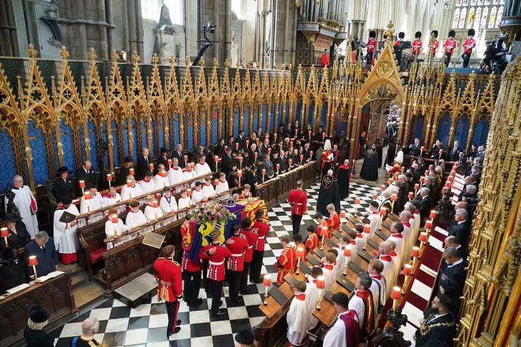 The coffin of Queen Elizabeth II is carried from Westminster Abbey after the funeral service of Queen Elizabeth II at Westminster Abbey in central London, Monday Sept. 19, 2022. The Queen, who died aged 96 on Sept. 8, will be buried at Windsor alongside her late husband, Prince Philip, who died last year. (Dominic Lipinski/Pool via AP)