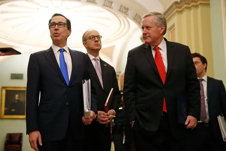 Treasury Secretary Steven Mnuchin, White House Legislative Affairs Director Eric Ueland and acting White House chief of staff Mark Meadow (from left to right) speaking with the media Tuesdayon Capitol Hill.