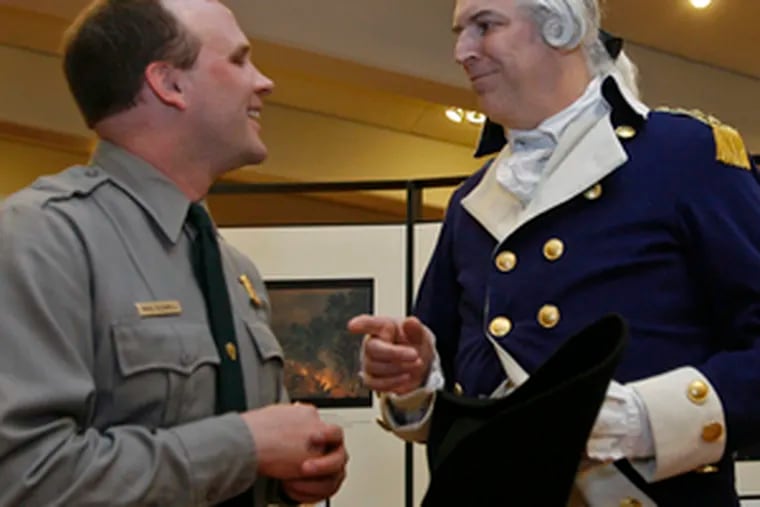 Mike Caldwell (left), Valley Forge superintendent, talks with Gen. Washington (Dean Malissa), during a reception detailing the new program.
