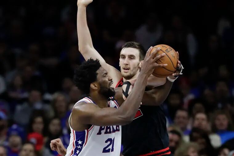 Sixers center Joel Embiid gets fouled attempting to layup against Chicago forward Luke Kornet on Sunday.