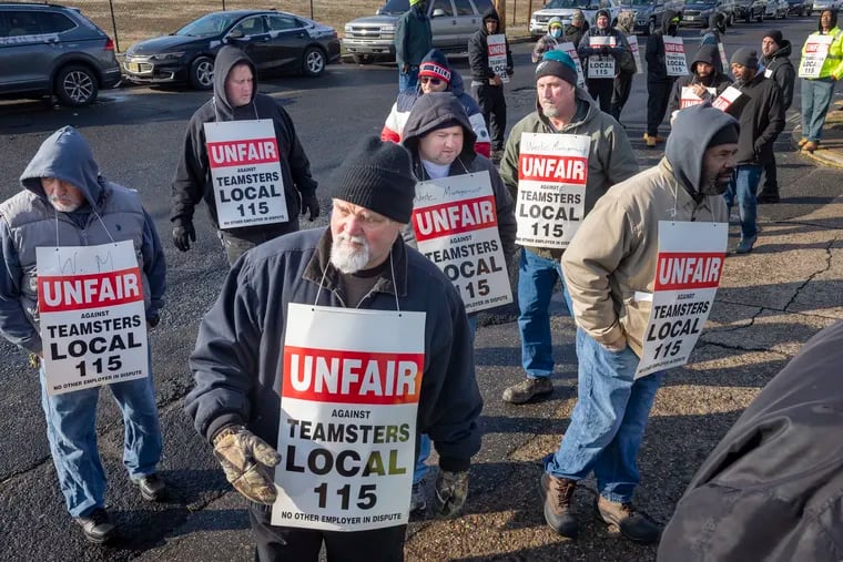 Striking workers represented by Teamsters Local 115 picket outside Waste Management facility in Camden on Wednesday. The company provides residential trash pickup services in the city as well as in Haddonfield and Winslow Township in Camden County.