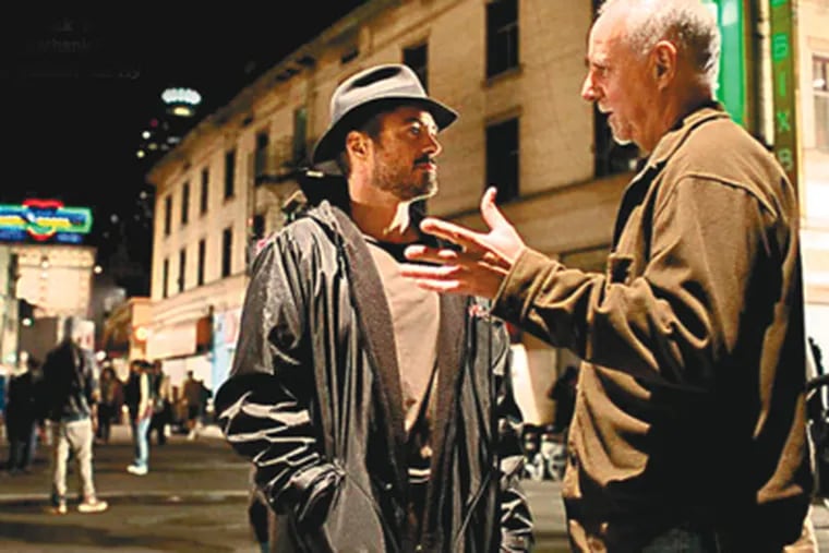 Actor Robert Downey Jr., left, who portrays columnist Steve Lopez, confers with Lopez himself during filming of 'The Soloist.' Jamie Foxx plays Nathaniel Ayers, the homeless man befriended by Lopez. (Francois Duhamel)