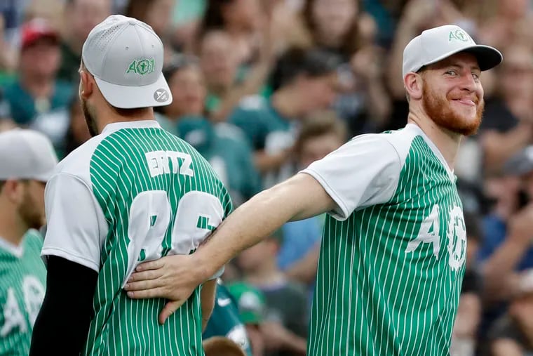 Eagles tight end Zach Ertz gets a tap from quarterback Carson Wentz (right) while Ertz participated in the home run hitting contest during the Carson Wentz charity softball game at Citizens Bank Park on Friday, May 31, 2019.