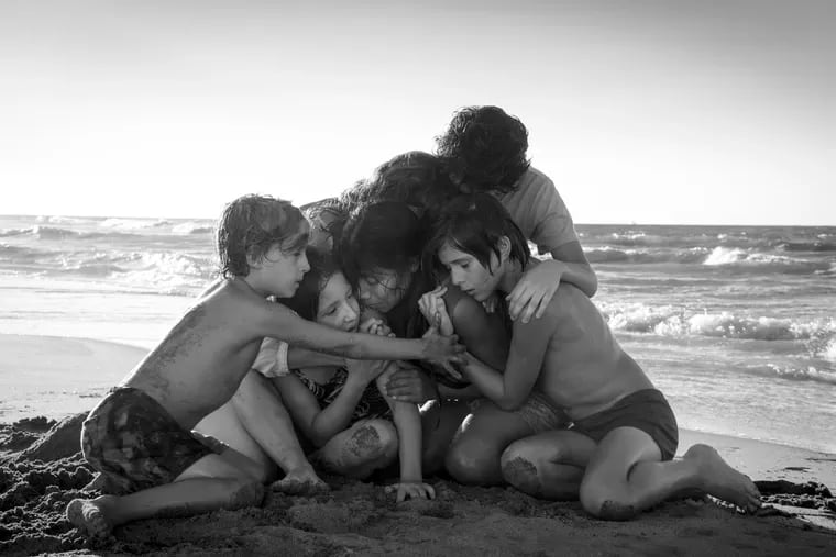 This image released by Netflix shows Yalitza Aparicio, center, in a scene from the film "Roma," by filmmaker Alfonso Cuaron. The film has dominated the New York Film Critics Circle Awards, winning best film, best director and best cinematography. The film is Netflix’s most acclaimed release yet, and it’s widely expected to contend for best picture at the Academy Awards. (Carlos Somonte/Netflix via AP)