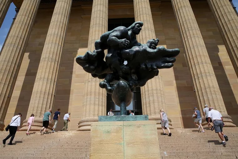 Visitors stream past Jacques Lipchitz's "Prometheus Strangling the Vulture" on their way into he Philadelphia Museum of Art on Wednesday morning.