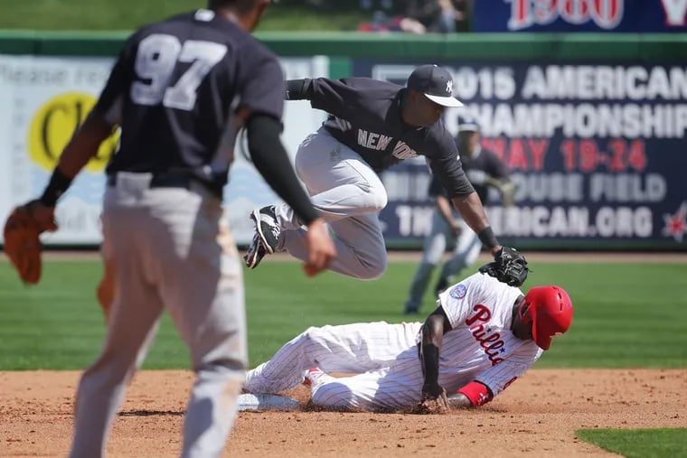 Jose Pirela, who joined the Phillies on Saturday, tags out Ryan Howard during spring training in 2015 when Pirela was playing for the Yankees. ( DAVID SWANSON / Staff Photographer )