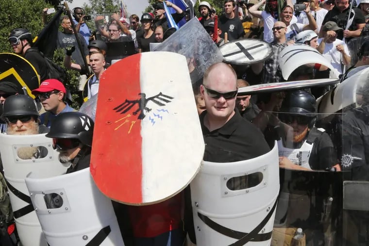 White nationalist  demonstrators protesting plans to take down Confederate Gen Robert E. Lee’s statue use shields as they block the entrance to Lee Park in Charlottesville, Va., Aug. 12, 2017.