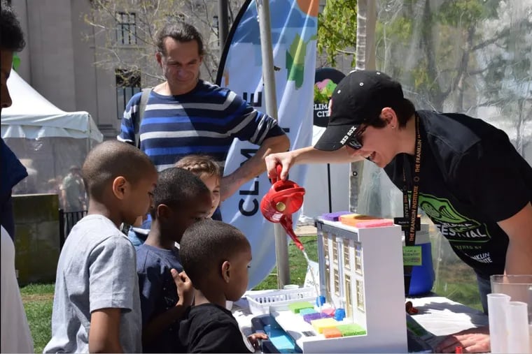 The Franklin Institute's Rachel Valletta hosts a climate change activity with children at the 2018 Philadelphia Science Festival.