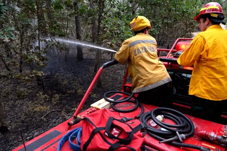 File: Firefighters monitoring hot areas after a June, 2022 fire in Wharton State Forest. A fire that broke out April 24, 2024, reached 500 acres before it was fully contained.