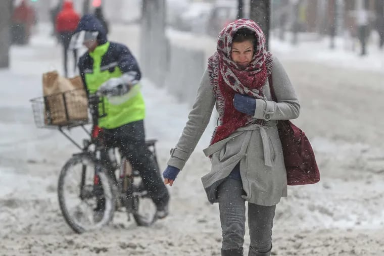 A pedestrian crossing the very windy intersection of 19th and Market shows her displeasure as the wind whips the snow into her face during the snow storm that hit the region on Thursday, Jan. 4, 2018.