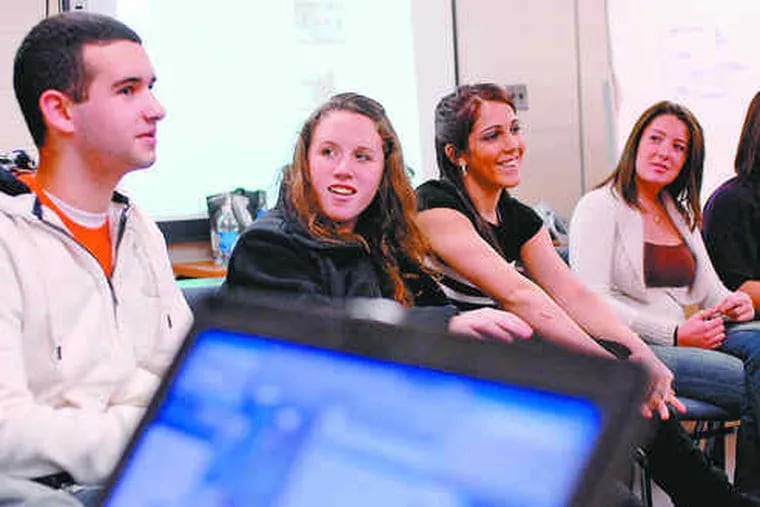 Springfield High students (from left) Rob Toomey, Mary Reilly, Elizabeth Koppe and Staci Rice discuss their coverage of the inauguration. The Delaware County school is participating in a statewide project.