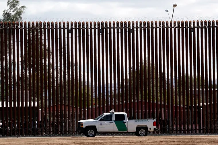 FILE - In this April 5, 2019, file photo, a U.S. Customs and Border Protection vehicle sits near the wall as President Donald Trump visits a new section of the border wall with Mexico in El Centro, Calif. The Supreme Court has cleared the way for the Trump administration to tap Pentagon funds to build sections of a border wall with Mexico.