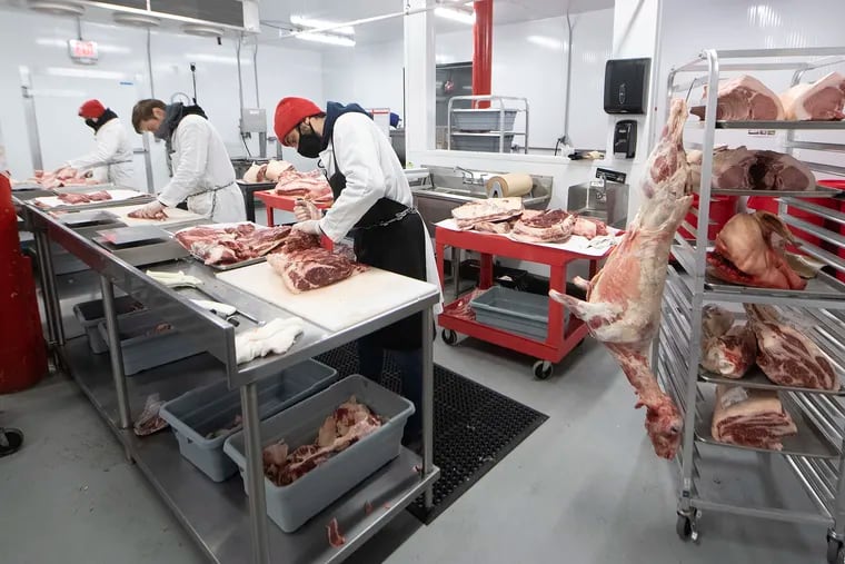 Staff butchers cut meat at Primal Supply Brewerytown HQ.