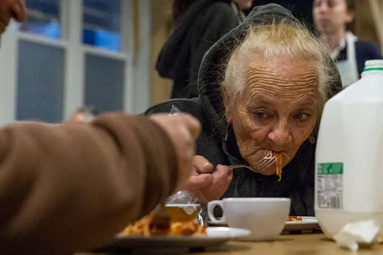 Joanne Riley, 67, of Kensington, eats spaghetti at St. Francis Inn, 2441 Kensington Ave., during one of its free dinners.