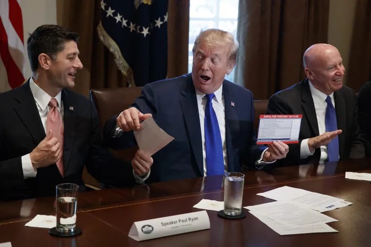 The Republican tax bill released Thursday would tax excess executive pay at nonprofits. Speaker of the House Rep. Paul Rya (left) hands President Trump an example of what a new tax form may look like during a meeting on tax policy with Republican lawmakers in the Cabinet Room of the White House on Thursday. At right is chairman of the House Ways and Means Committee Rep. Kevin Brady (R., Texas).