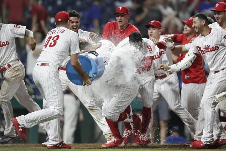 The Phillies' Trevor Plouffe is doused by Nick Pivetta after Plouffe hit a game-winning home run in the 16th inning against the Dodgers Wednesday morning.