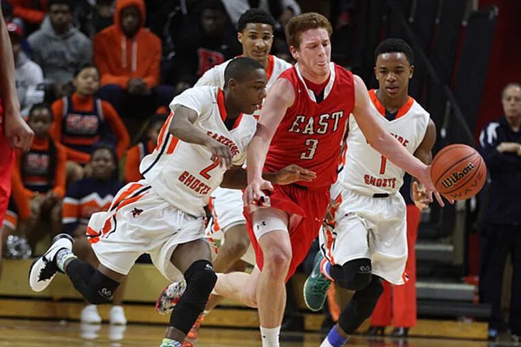 Cherry Hill East's #3, Jake Silpe, center, is harassed by Paterson Eastside's #2, Aaryn Abrams, left, as he tries to bring the ball up on offense during the third quarter. (Michael Bryant/Staff Photographer)