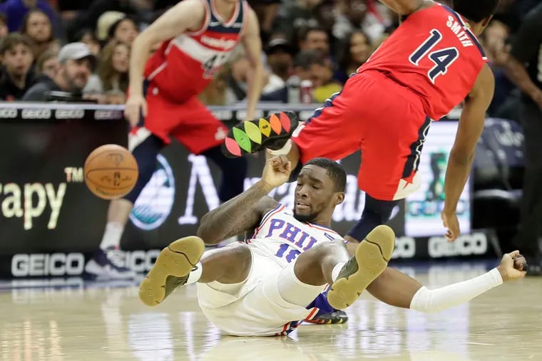 Shake Milton hits the floor after diving for a loose ball in the first half of the Sixers' preseason loss to Washington Friday night.