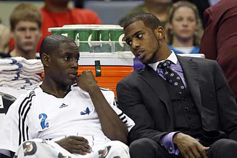 The Sixers won't have to face Hornets star point guard Chris Paul, right, tonight as they play New Orleans. (AP Photo / Patrick Semansky)