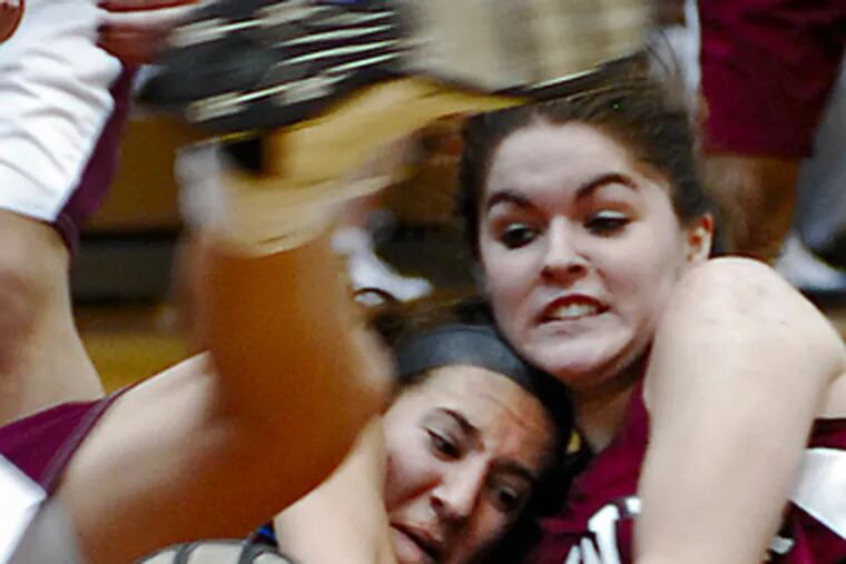 Lower Merion&#0039;s Molly Hanlon (right) battles Radnor&#0039;s Beth Ellis underneath the basket for a loose basketball.