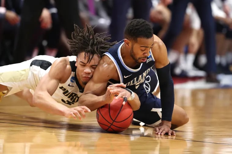 Carsen Edwards, left, of Purdue and Phil Booth of Villanova go after a loose ball during the first half of a 2nd round NCAA Tournament game at the XL Center in Hartford, CT on March 23, 2019.