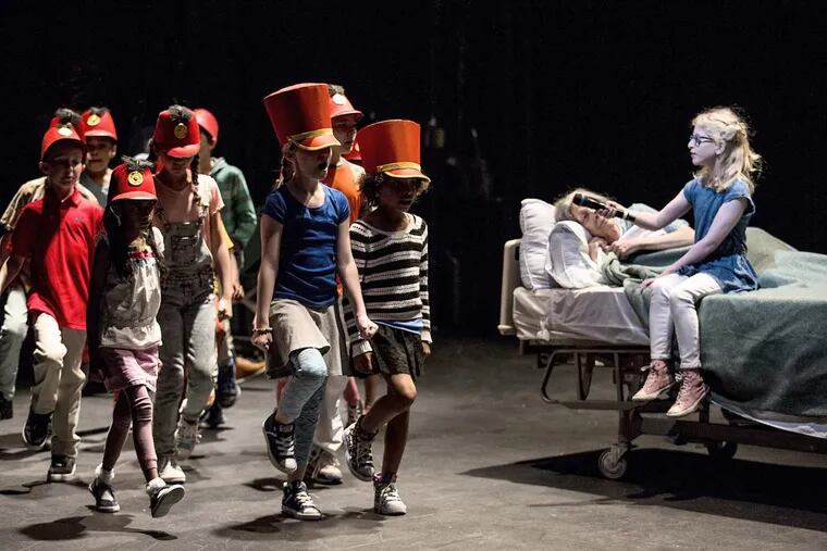 Nancy Boykin (in bed) with Margalit Eisenstein and a children’s choir in Pig Iron’s “A Period of Animate Existence.”