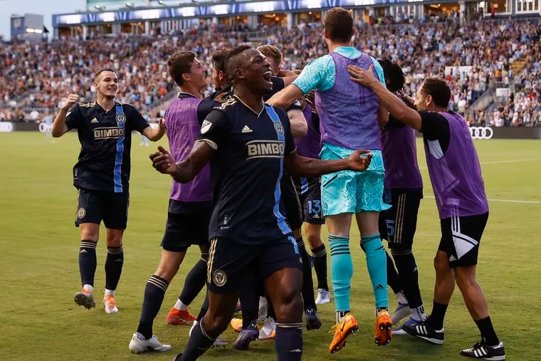 Cory Burke (center) celebrates his dramatic game-winning goal for the Union against New York City FC.