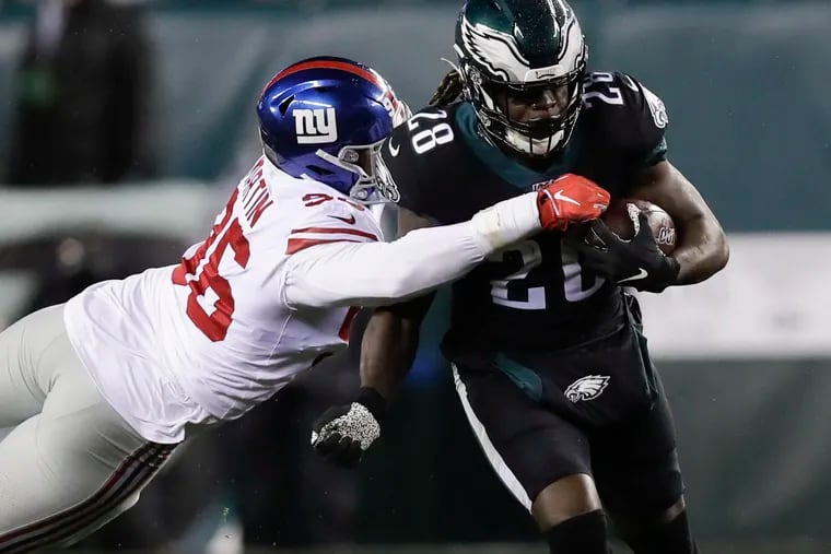 Eagles running back Jay Ajayi tries to escape New York Giants outside linebacker Kareem Martin on Dec. 9.