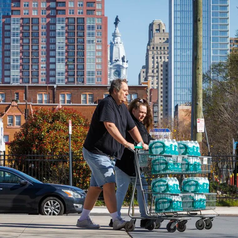 Customers buy water at Sprouts at South Broad and Carpenter in Philadelphia after a shipment arrived Monday morning.