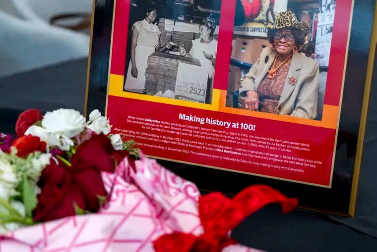 A photo of Daisy Lee Riley from her early working days and one from her 100th birthday last December are displayed as Campbell Soup Co. dedicates a conference room at their Camden headquarters Thursday, Feb. 15, 2024 in honor of  the company’s first Black female employee, hired in 1943. Asked once for her secret for a long life Riley replied, “Serving the Lord, doing right, and eating and drinking well.”