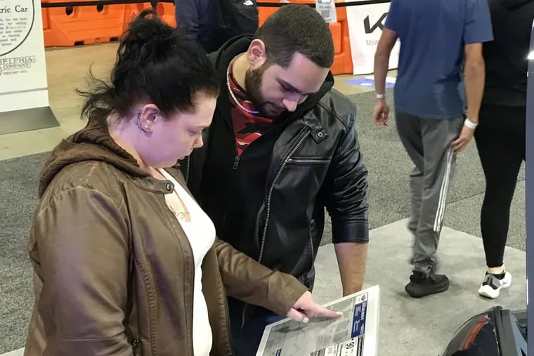 Ashley Vorndran and Jacob Gines-Santiago, both of Bethlehem, checked out the Ford Mustang Mach-E electric vehicle at the Philadelphia Auto Show on Sunday.