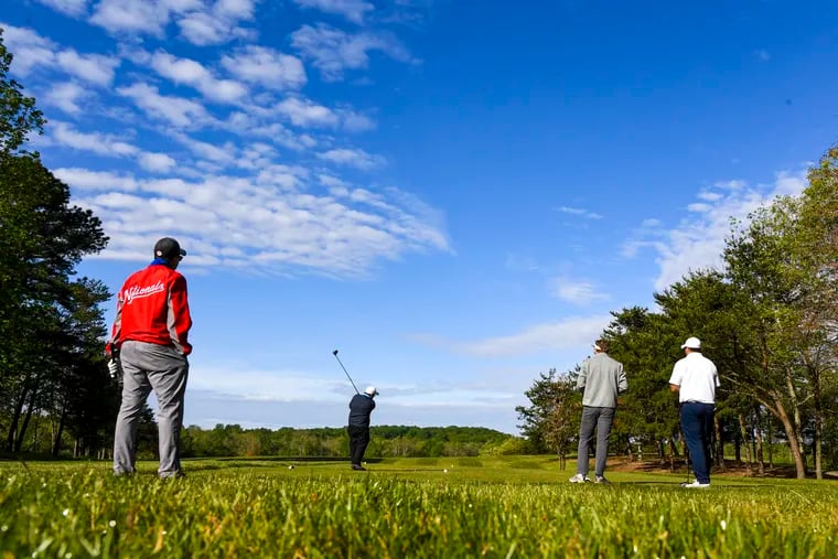 Lonnie Swindell tees off at Renditions Golf Course in Anne Arundel County, Md., as fellow golfers, from left, Jeff Chapman, Sean Walsh and Tim Rose keep their distance. MUST CREDIT: Washington Post photo by Jonathan Newton.