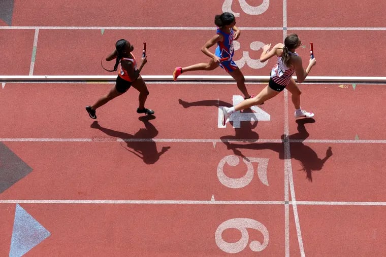 Girls run in the high school 4x400 during the 128th Penn Relays at Franklin Field on April 25.