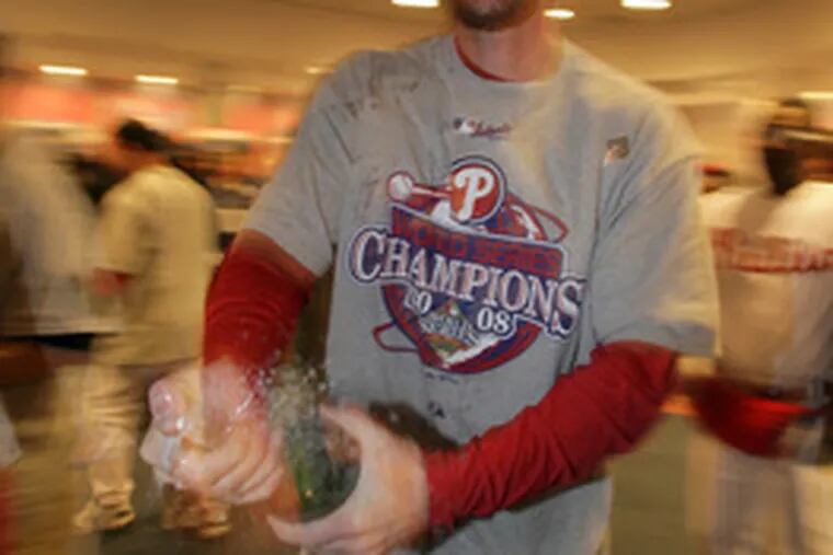 Brad Lidge celebrates with champagne after saving the series-clincher.