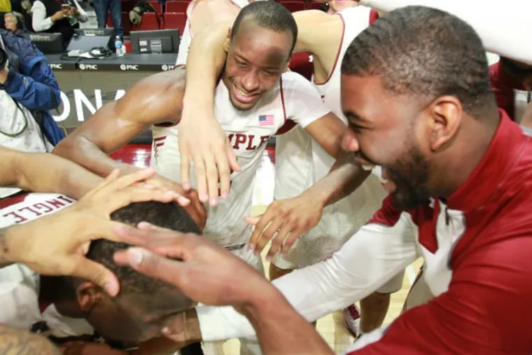 Temple players celebrate their win in the NIT quarterfinals. (Charles Fox/Staff Photographer)