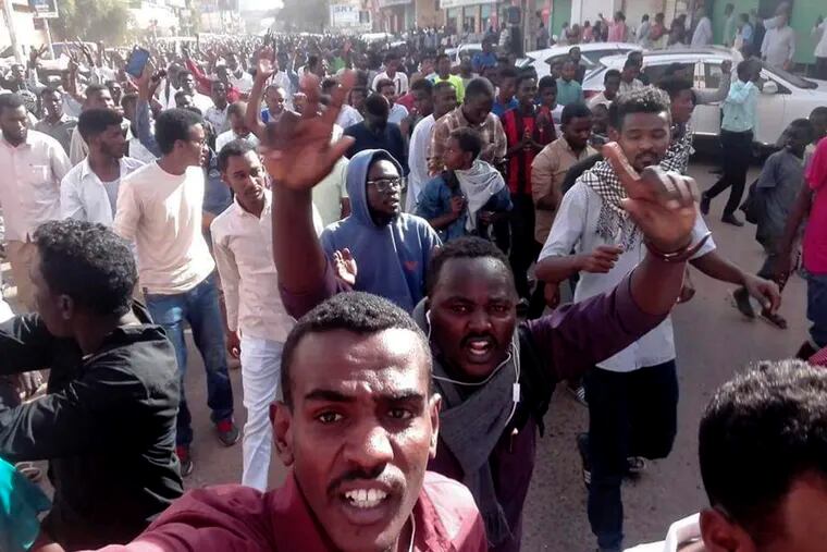 In this Thursday, Dec. 20, 2018 handout photo provided by a Sudanese activist, protesters chant slogans during a demonstration, in Khartoum, Sudan. The protest was one in a series of anti-government protests across Sudan, initially sparked by rising prices and shortages. (Sudanese Activist via AP)