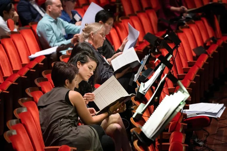Composers Nina C. Young, Hilary Purrington, Chen-Hui Jen (obscured), Robin Holcomb, and Xi Wang listen as Melody Eötvös's The Saqqara Bird is rehearsed.