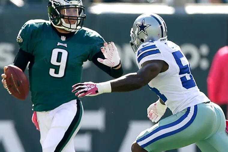 Philadelphia Eagles quarterback Nick Foles (9) runs with the ball with Dallas Cowboys outside linebacker Bruce Carter (54) in pursuit during the first half. (AP Photo/Matt Rourke)