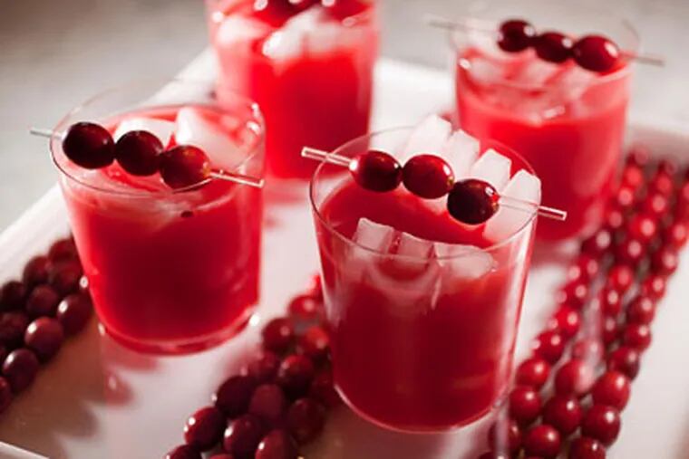 Cranberry-tinis on a square tray lined with cranberries by Peter Callahan. Get the recipe <a href="http://www.philly.com/philly/restaurants/recipes/134778028.html"> here</a>. (David M Warren / Staff Photographer)