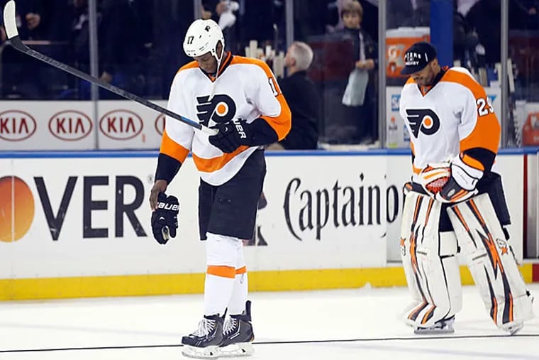 Wayne Simmonds and Ray Emery skate off the ice after losing to the Rangers. (Yong Kim/Staff Photographer)