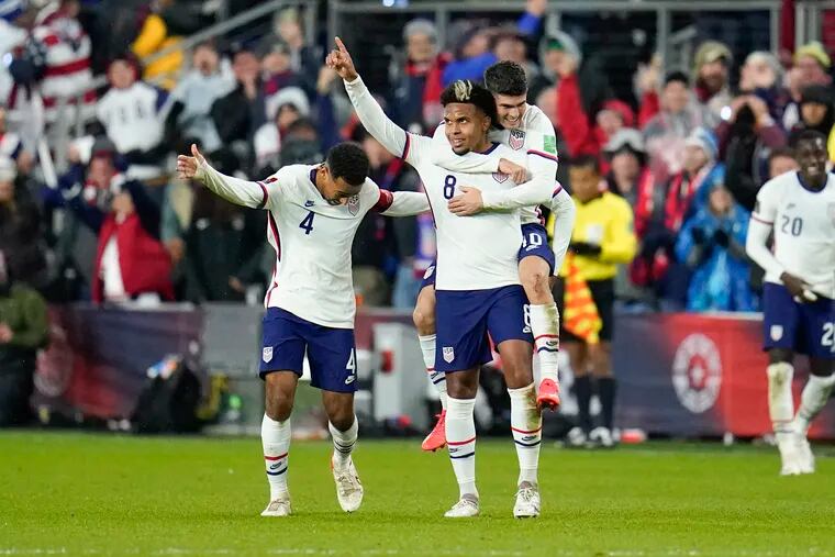 Weston McKennie (center) celebrates with fellow scorer Christian Pulisic (right) and Tyler Adams (left) after delivering the United States' second goal.