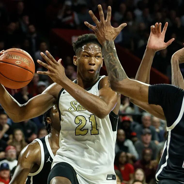 Neumann Goretti Larenzo Jerkins looks to pass around Archbishop Ryan Darren Williams during the 2nd quarter of the Catholic League boys semifinals at the Palestra, Wednesday, February 21, 2024.