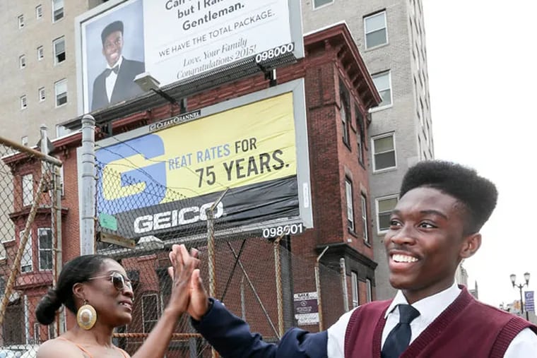 Aljelani Igwe, set to graduate from LEAP Academy next week, was surprised by his mother, Ovella O’Neal, and other family members with sweets and a billboard message. (STEVEN M. FALK/Staff Photographer)