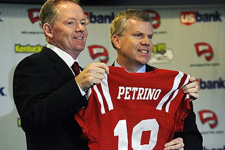 New Western Kentucky head coach Bobby Petrino, left, holds up a jersey with athletic director Todd Stewart during an NCAA college football news conference. (Joe Imel/AP)